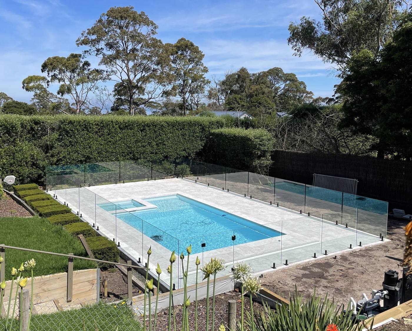 Aerial view of a glass fenced pool with garden